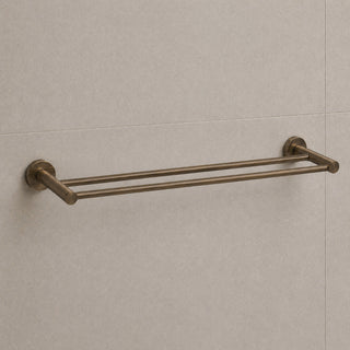 antique brass towel bar mounted on a tiled wall