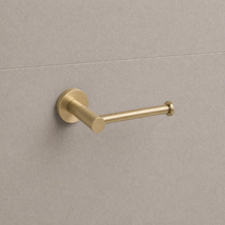 Reno brushed brass toilet roll holder on white background full view