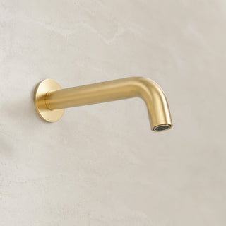 Reno brushed brass wall spout tap on white background full view