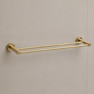 Gold towel rack on a beige tiled wall