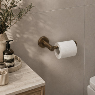 antique brass toilet roll holder in a modern bathroom with a timber vanity