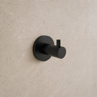 Black wall hook on a beige wall