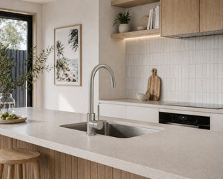 Modern kitchen with sink, countertop, and decorative elements.