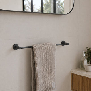matt black single towel rail on a beige tile wall in a modern bathroom with a timber vanity